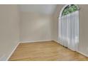 Bright room with hardwood floors, an arched window, and neutral walls; perfect for an office or reading nook at 1558 Ember Oaks Cir, Powder Springs, GA 30127