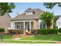 Beautiful single-Gathering home featuring a cozy front porch and lush green lawn at 753 Cambron Commons Trce, Suwanee, GA 30024
