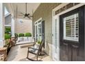 Cozy front porch with rocking chair and swing, offering a relaxing outdoor space by the front door at 753 Cambron Commons Trce, Suwanee, GA 30024