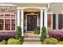 Inviting front entrance with stone accents, double doors, and meticulously maintained landscaping at 963 Manor Parc Dr, Decatur, GA 30033