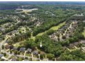 An aerial view showcases the neighborhood's lush greenery and the home's prime location near the golf course at 1348 Bridgemill Ave, Canton, GA 30114