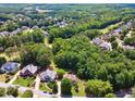 An aerial view of the house with mature trees and landscaping provides a serene and private setting at 1348 Bridgemill Ave, Canton, GA 30114