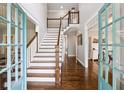The bright foyer features a staircase and hardwood floors, creating a welcoming entrance to the home at 1348 Bridgemill Ave, Canton, GA 30114
