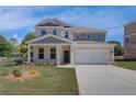 Charming two-story home with a two-car garage and a well-maintained lawn at 281 Chiswick Loop, Stockbridge, GA 30281