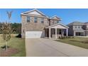 Attractive brick home with an attached two-car garage and a manicured lawn, offering curb appeal at 281 Chiswick Loop, Stockbridge, GA 30281