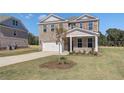 Charming two-story brick home with an attached garage, landscaped lawn, and inviting front entrance at 281 Chiswick Loop, Stockbridge, GA 30281