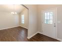 Bright entryway with hardwood floors and elegant archway leading to dining area at 363 Chadwick Cmn, Stockbridge, GA 30281