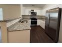 Modern kitchen with granite countertops, stainless steel appliances, and white cabinetry at 363 Chadwick, Stockbridge, GA 30281