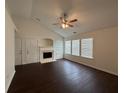 Cozy living room featuring a fireplace, vaulted ceilings, and multiple windows for ample natural light at 363 Chadwick, Stockbridge, GA 30281
