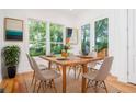Dining room with a wooden table and beige upholstered chairs illuminated by lots of natural light at 140 Racine Sw St, Atlanta, GA 30314