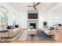 Bright living room featuring a modern fireplace, light hardwood floors, and stylish furniture with pops of navy at 140 Racine Sw St, Atlanta, GA 30314
