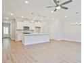 Bright, open-concept kitchen with white cabinets, island, pendant lighting and stainless steel appliances at 162 Bluffington Way, Marietta, GA 30066