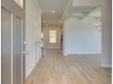 Inviting home entryway with hardwood floors, and modern gray paint that leads to a spacious living area at 257 Chiswick Loop, Stockbridge, GA 30281