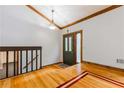 Inviting foyer with decorative lighting, wooden trim, and hardwood floors leading to the staircase at 288 Shire Way, Lawrenceville, GA 30044