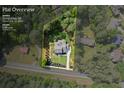 Aerial view showcasing the home's setting on a 1-acre lot, surrounded by lush greenery and mature trees at 10350 Alvin Rd, Johns Creek, GA 30022