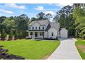 Beautiful two-story home with a modern farmhouse design, attached garage, and well-manicured lawn at 10350 Alvin Rd, Johns Creek, GA 30022
