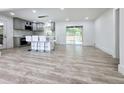 Open-concept kitchen featuring a modern island with seating, new appliances, and sliding glass doors to a deck at 2400 Glenrock Dr, Decatur, GA 30032