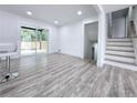 Living room featuring sliding glass doors to the backyard deck and stairs to the upper or lower level at 2400 Glenrock Dr, Decatur, GA 30032