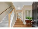 Inviting foyer with hardwood floors, staircase, and view into the adjacent kitchen area at 260 Roberts Rd, Suwanee, GA 30024