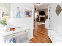 Inviting entryway with hardwood floors, console table, and a glimpse into the living room with a fireplace at 3514 Ethridge Nw Ln, Kennesaw, GA 30144