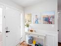 Bright entryway featuring white wainscoting, console table, and artwork on the wall at 3514 Ethridge Nw Ln, Kennesaw, GA 30144