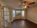 Bright room featuring hardwood floors, a modern ceiling fan, and lots of natural light at 257 Juliet Dr, Hampton, GA 30228