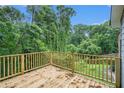 Spacious wood deck overlooking a serene backyard with lush trees and greenery at 1285 North Nw Ave, Atlanta, GA 30318