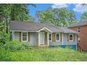 Single-story home boasting neutral siding, rustic shutters and covered entryway at 1285 North Nw Ave, Atlanta, GA 30318