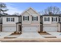 New townhomes in a row feature neutral colors, garage and inviting curb appeal on a sunny day at 504 Amethyst Way, Stockbridge, GA 30281