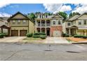 A row of suburban homes each with garages and driveways lining the street at 334 Pin Oak Ave, Woodstock, GA 30188