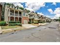 A street of suburban homes with well-manicured front yards and driveways in a residential neighborhood at 334 Pin Oak Ave, Woodstock, GA 30188