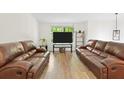 Bright living room features hardwood floors, a large window, and leather sofas at 3512 Lynview W Ct, Decatur, GA 30034