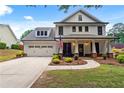 Charming two-story home with a manicured front yard, two-car garage, covered entryway, and an American flag at 4092 Grand Park Dr, Suwanee, GA 30024