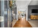 Inviting foyer with hardwood floors, views of the living spaces, and a decorative wreath on the front door at 4092 Grand Park Dr, Suwanee, GA 30024