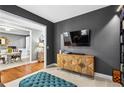 Open living area featuring a TV, wooden cabinet, views of the dining area, and neutral wall colors at 4092 Grand Park Dr, Suwanee, GA 30024
