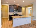 Spacious kitchen with large island, granite countertops and modern stainless steel appliances at 4605 Fourth Rail Ln, Cumming, GA 30040