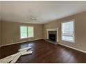 Cozy living room featuring wood-look flooring, a ceiling fan, and a classic fireplace at 554 Oak Landing Cir, Douglasville, GA 30134