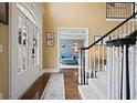 Warm foyer with a staircase, hardwood floors, and elegant details, creating a welcoming first impression at 6317 Benbrooke Overlook Nw, Acworth, GA 30101
