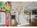 Inviting foyer with hardwood floors, a staircase with white railings, and a view into other living spaces at 6317 Benbrooke Overlook Nw, Acworth, GA 30101