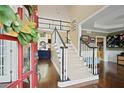 Elegant foyer showcasing hardwood floors, staircase with black and white banister, and open floor plan at 6317 Benbrooke Overlook Nw, Acworth, GA 30101