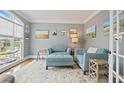 Comfortable sitting room with large windows, blue couches, and decorative rug at 6317 Benbrooke Overlook Nw, Acworth, GA 30101