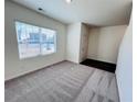 Cozy carpeted room with a window, door and hardwood flooring, offering a versatile space at 7775 Sudbury Cir, Covington, GA 30014
