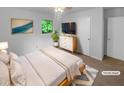 Bright bedroom featuring a neutral palette, carpeted floors, and a picture window overlooking the backyard at 2060 Devore Sw Dr, Marietta, GA 30008