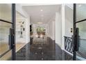 Grand foyer featuring marble floors, glass paneled double doors, and open view to living spaces at 2837 Darlington Run, Duluth, GA 30097