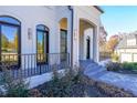 Inviting front porch with sleek black trim, modern lighting, and well maintained walkway at 2837 Darlington Run, Duluth, GA 30097