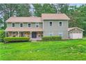Lovely home featuring a well-maintained lawn and a detached garage at 4826 Dean Sw Ln, Lilburn, GA 30047
