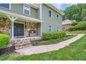 Close up of the exterior showcasing stone detail and a welcoming front porch at 4826 Dean Sw Ln, Lilburn, GA 30047