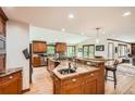 Spacious kitchen with wood cabinets, granite countertops, stainless steel appliances and an island with seating at 4826 Dean Sw Ln, Lilburn, GA 30047