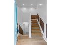 Entryway with wooden staircase and combination paint/wood-paneled walls at 5250 Forest Downs Ln, Atlanta, GA 30349