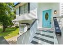 Inviting entryway with a vibrant blue front door and freshly painted steps at 5250 Forest Downs Ln, Atlanta, GA 30349